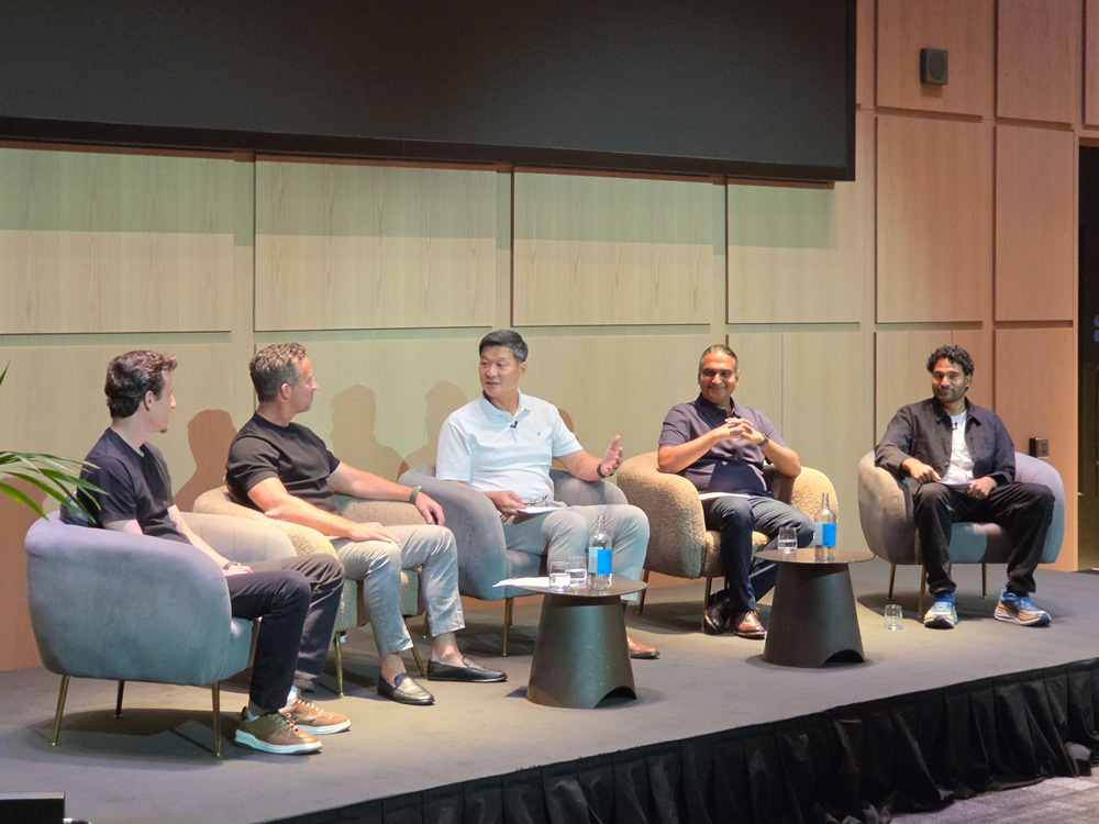 A group of men sitting in chairs on a stage
